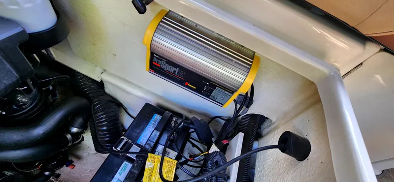 Slide: The Image of Battery compartment of 2017 Sea Ray SDX 220 with charger and wiring. - 22