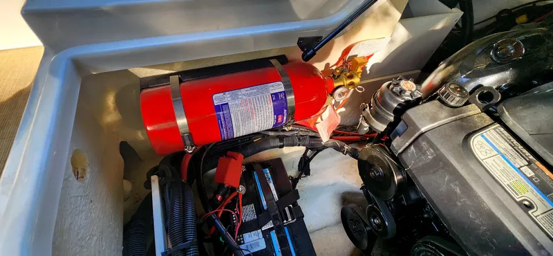 Slide: The Image of Engine compartment of 2017 Sea Ray SDX 220 with fire extinguisher and battery. - 23