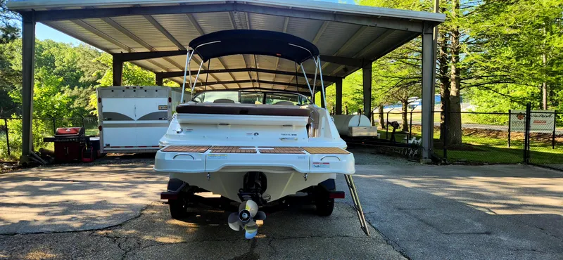 Slide: The Image of 2017 Sea Ray SDX 220 boat parked under a canopy, rear view. - 3