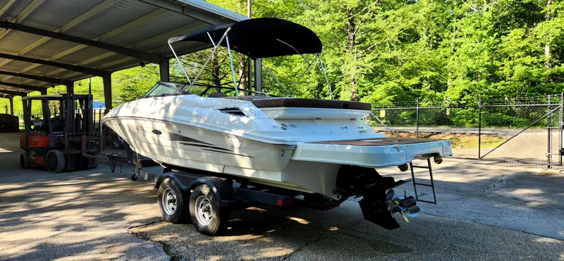 Slide: The Image of 2017 Sea Ray SDX 220 boat on trailer under canopy, surrounded by trees. - 4