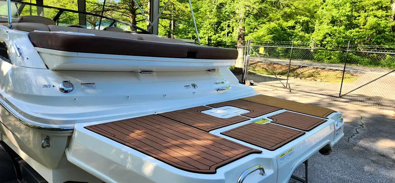 Slide: The Image of 2017 Sea Ray SDX 220 boat with teak swim platform in a sunny outdoor setting. - 7