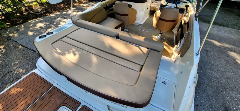 Slide: The Image of 2017 Sea Ray SDX 220 boat interior with tan seating and wooden deck. - 9