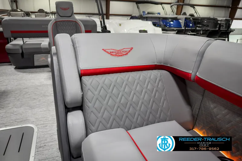Slide: The Image of 2025 Bennington 24 MSB boat interior with gray and red seating, diamond stitching, and logo. - 20