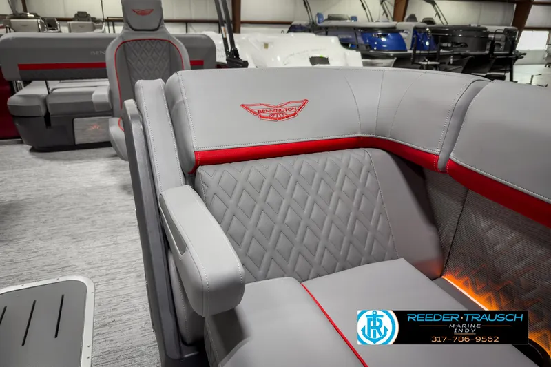 Slide: The Image of 2025 Bennington 24 MSB boat interior with gray and red seating, diamond stitching, and logo. - 21