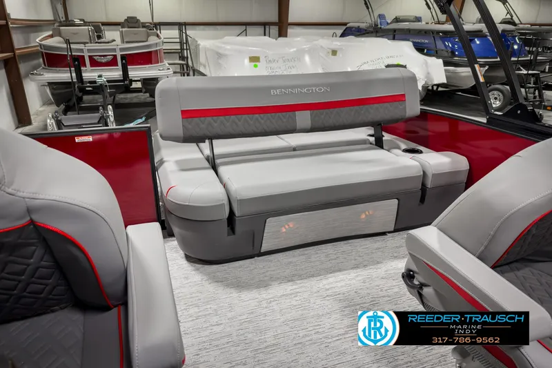 Slide: The Image of 2025 Bennington 24 MSB boat interior with gray and red seating, showroom display. - 29
