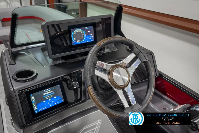 Slide: The Image of 2025 Bennington 24 MSB boat dashboard with modern steering wheel and digital displays. - 31