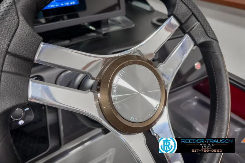 Slide: The Image of Steering wheel of 2025 Bennington 24 MSB boat, featuring sleek metallic design. - 32