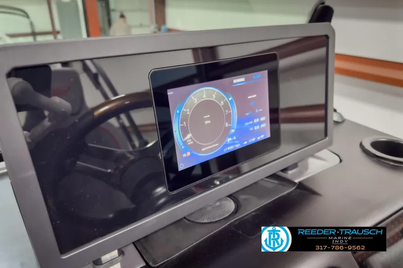 Slide: The Image of 2025 Bennington 24 MSB dashboard with digital display, featuring Reeder-Trausch Marine branding. - 34