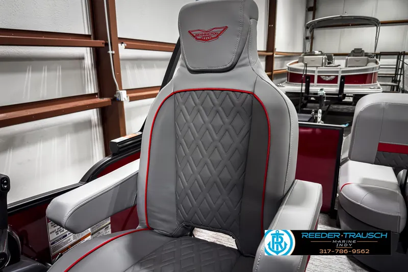 Slide: The Image of 2025 Bennington 24 MSB boat seat with diamond stitching and red accents in a showroom. - 36
