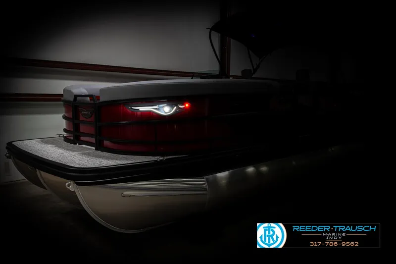 Slide: The Image of 2025 Bennington 24 MSB pontoon boat with sleek design and illuminated details in a dimly lit setting. - 4