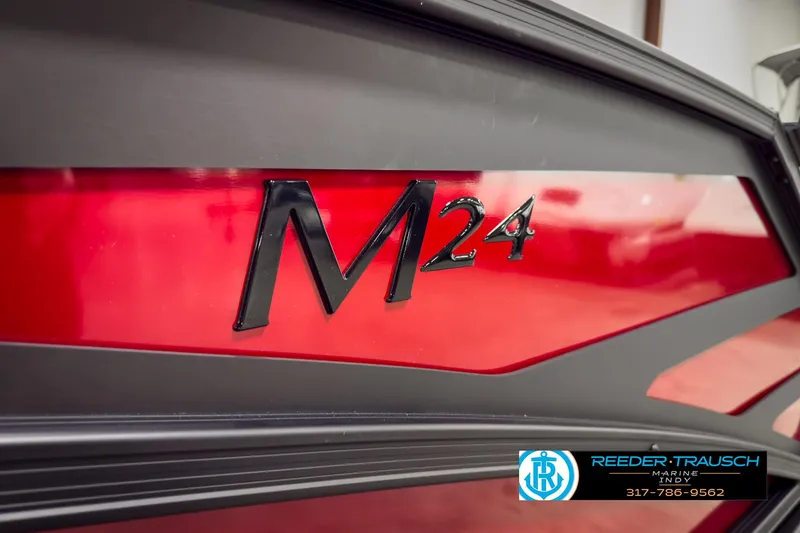 Slide: The Image of 2025 Bennington 24 MSB boat with sleek red and black design, M24 logo. - 44