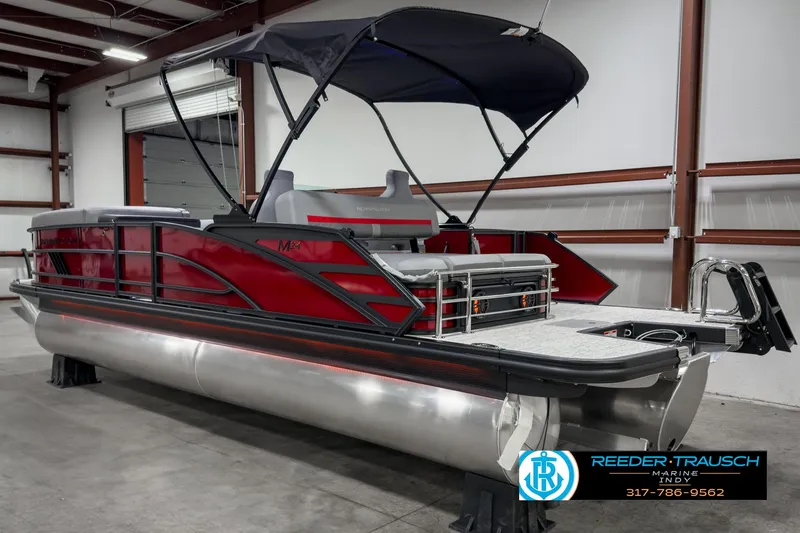 Slide: The Image of 2025 Bennington 24 MSB pontoon boat with canopy in a warehouse setting. - 6