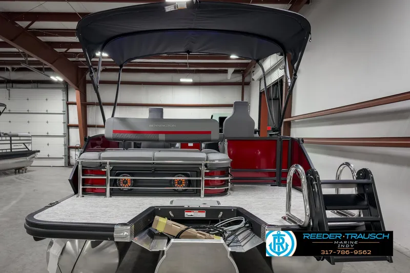 Slide: The Image of 2025 Bennington 24 MSB pontoon boat in a warehouse, featuring a sleek design and modern amenities. - 7