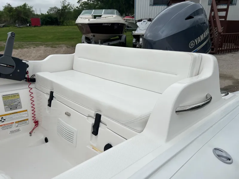 Slide: The Image of 2015 AB Inflatables Nautilus 12 DLX boat interior with white seating and Yamaha engine. - 2