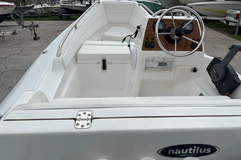 Slide: The Image of 2015 AB Inflatables Nautilus 12 DLX boat interior with steering wheel and seating. - 4