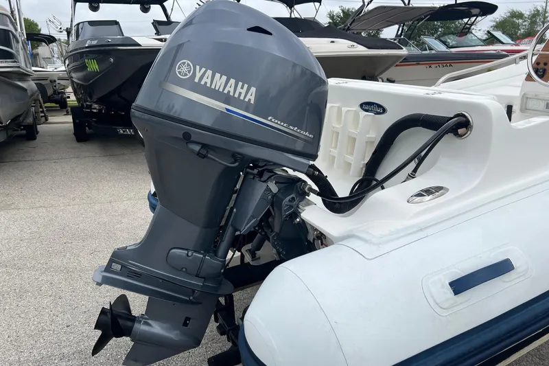 Slide: The Image of 2015 AB Inflatables Nautilus 12 DLX with Yamaha outboard motor in a marina setting. - 5