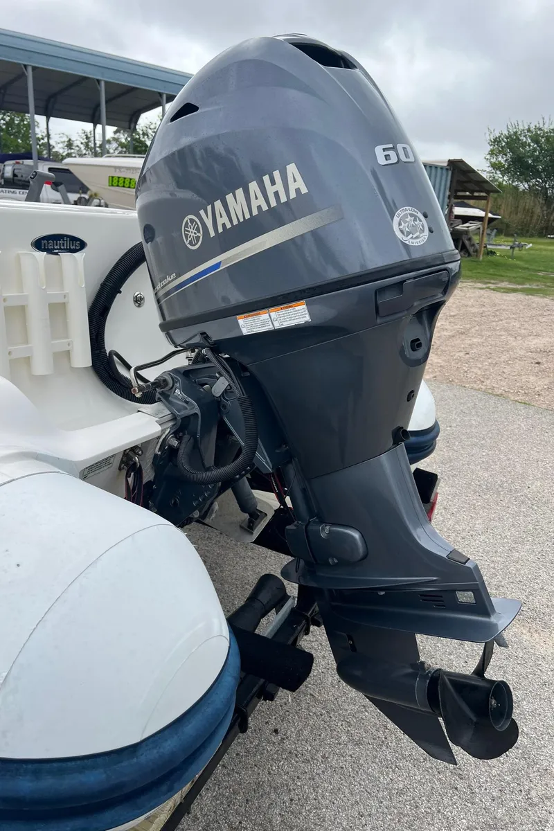 Slide: The Image of 2015 AB Inflatables Nautilus 12 DLX with Yamaha 60 outboard motor, parked outdoors. - 6