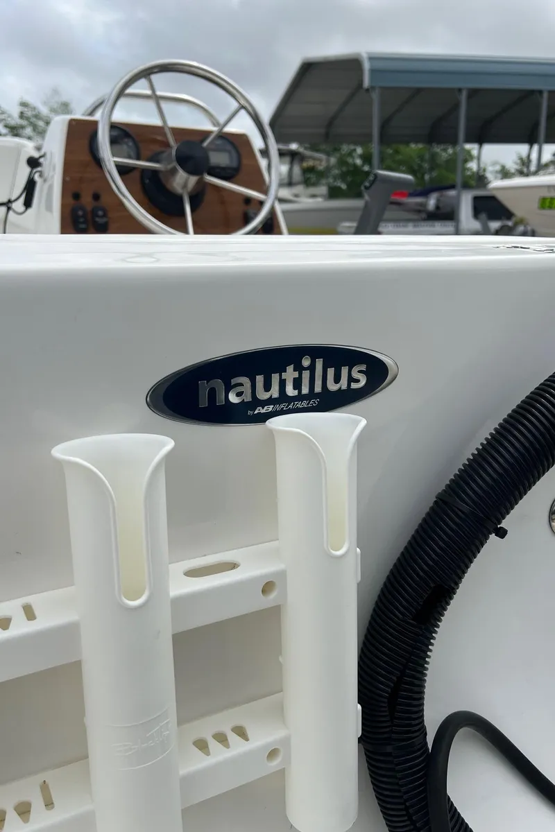 Slide: The Image of 2015 AB Inflatables Nautilus 12 DLX boat interior with steering wheel and logo. - 9