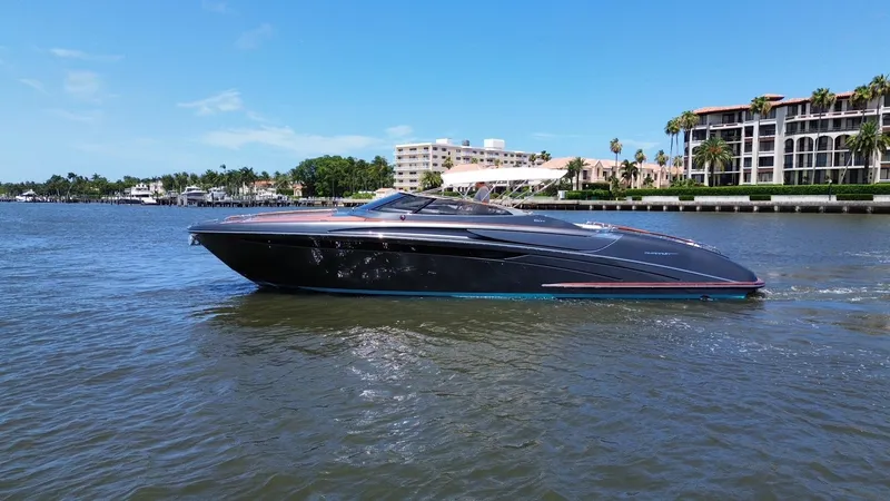 The Image of 2015 Riva Rivarama Super yacht cruising on a sunny day near waterfront buildings. - 0