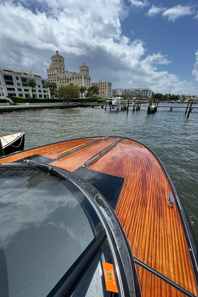 Slide: The Image of 2015 Riva Rivarama Super boat on water near elegant waterfront buildings. - 16