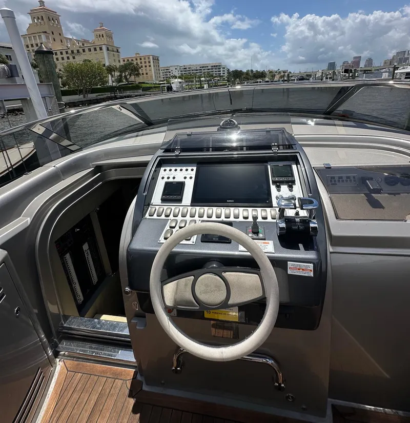 Slide: The Image of Cockpit of 2015 Riva Rivarama Super yacht with steering wheel and control panel, docked by waterfront. - 18
