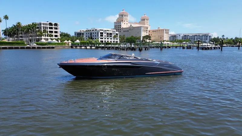 Slide: The Image of 2015 Riva Rivarama Super yacht on calm waters with cityscape background. - 2