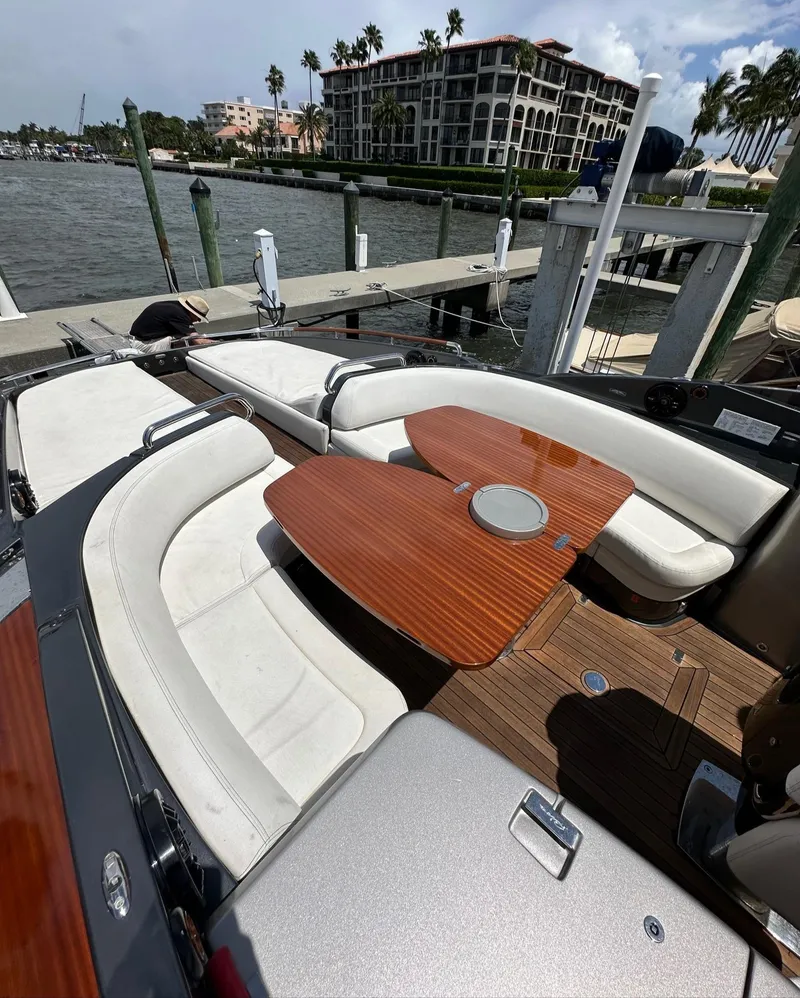 Slide: The Image of Luxurious 2015 Riva Rivarama Super yacht with elegant seating and wooden table, docked by waterfront. - 20