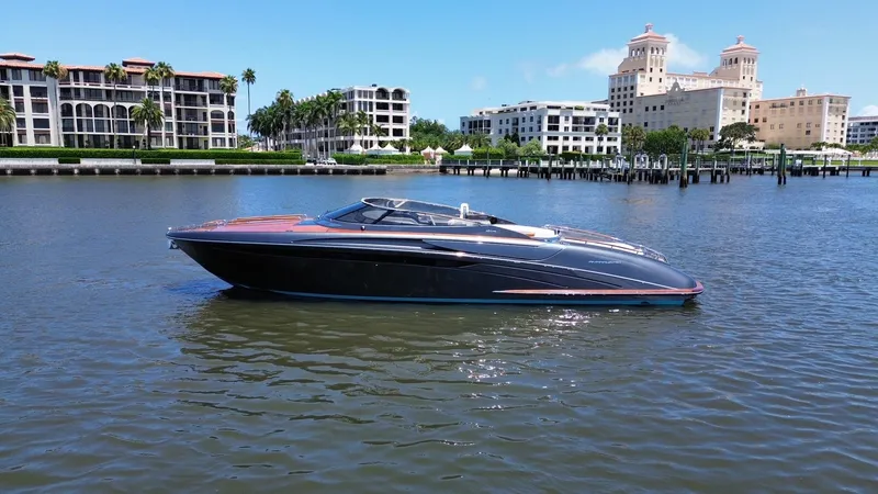 Slide: The Image of 2015 Riva Rivarama Super yacht on calm water with luxury buildings in the background. - 3