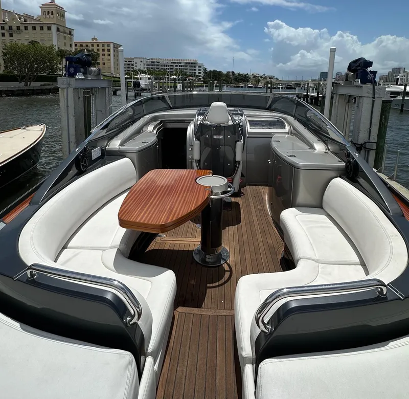 Slide: The Image of 2015 Riva Rivarama Super yacht with elegant seating and wooden deck, docked at marina. - 19