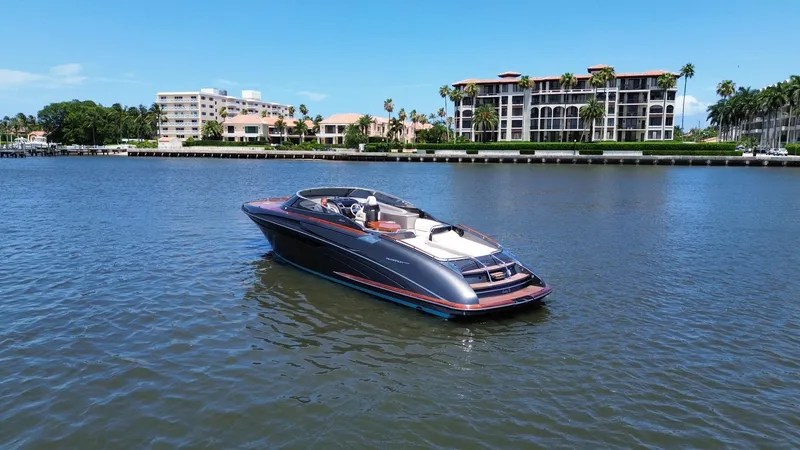 Slide: The Image of 2015 Riva Rivarama Super yacht cruising on a sunny waterfront with luxury buildings. - 4