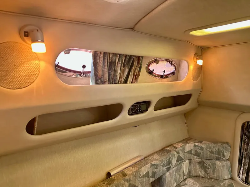 Slide: The Image of 1995 Sea Ray Sundancer cabin interior with cozy seating and ambient lighting. - 11