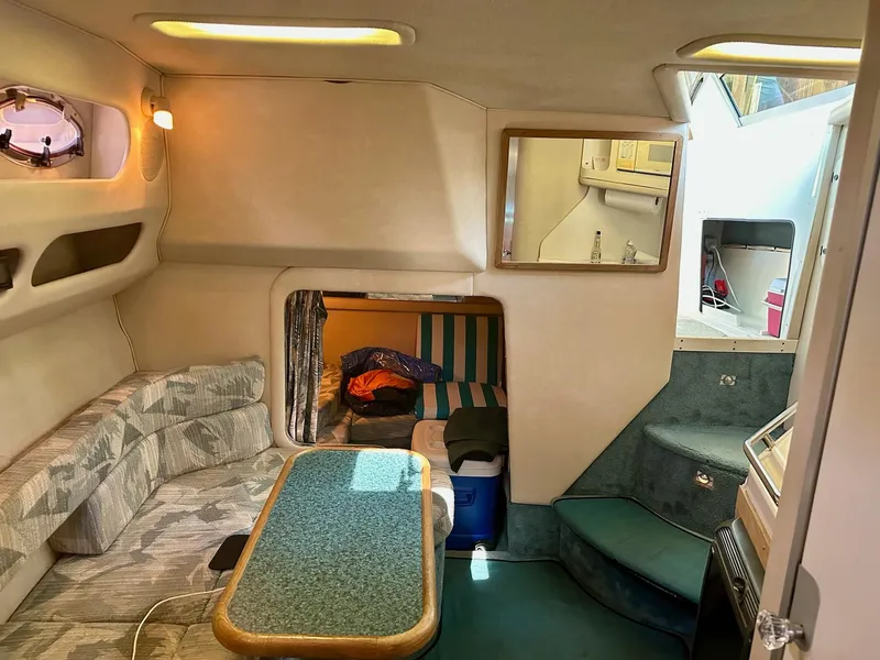 Slide: The Image of Interior of a 1995 Sea Ray Sundancer boat with seating and table. - 12
