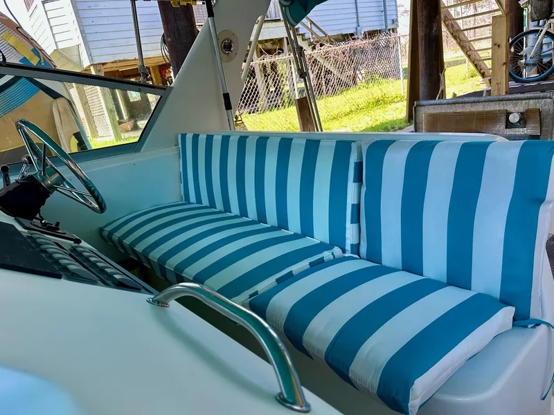Slide: The Image of 1995 Sea Ray Sundancer interior with blue and white striped seating. - 24