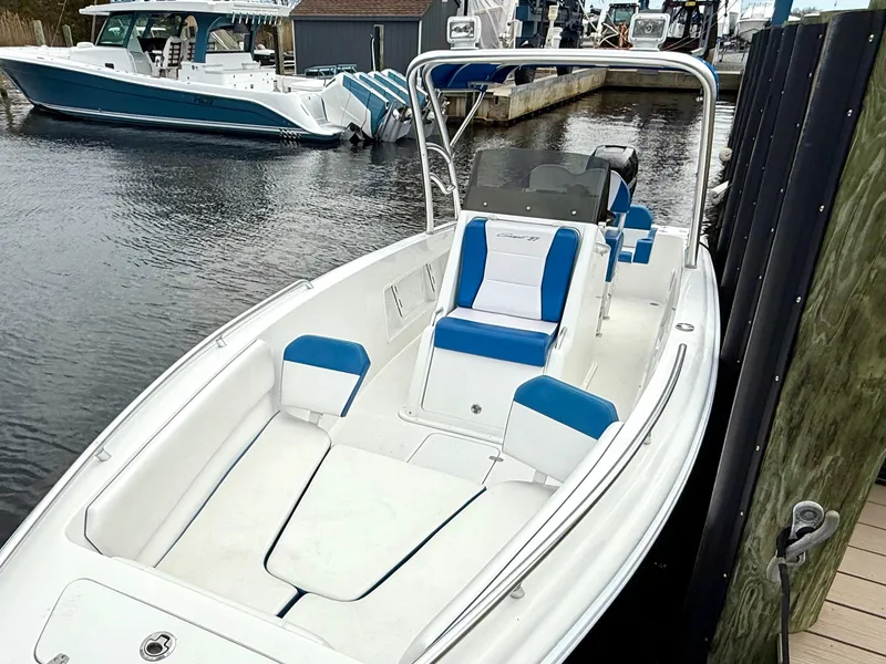 Slide: The Image of 2015 Concept 27' CC boat docked, featuring blue and white seating, sleek design. - 10