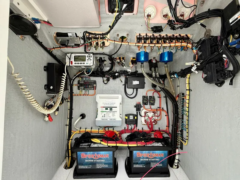 Slide: The Image of Electrical system setup in a 2015 Concept 27' CC boat, featuring batteries and wiring. - 14