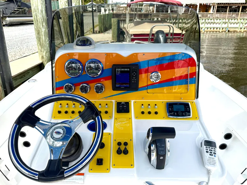 Slide: The Image of Colorful dashboard of a 2015 Concept 27' CC boat with steering wheel and controls. - 16