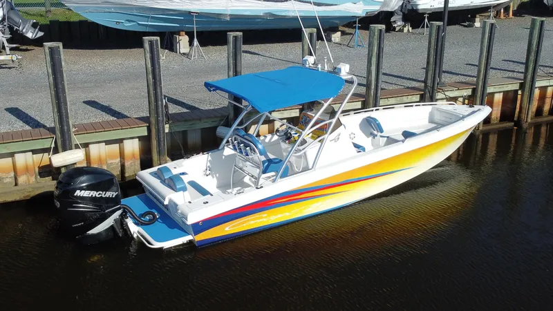 Slide: The Image of 2015 Concept 27' CC boat with vibrant stripes docked, featuring a blue canopy and Mercury outboard motor. - 2