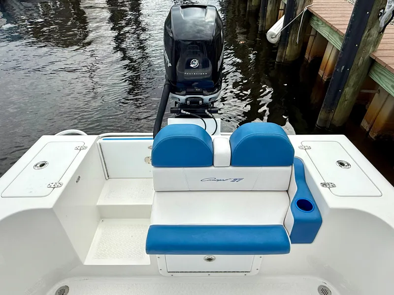 Slide: The Image of 2015 Concept 27' CC boat with blue seating and outboard motor at dock. - 25