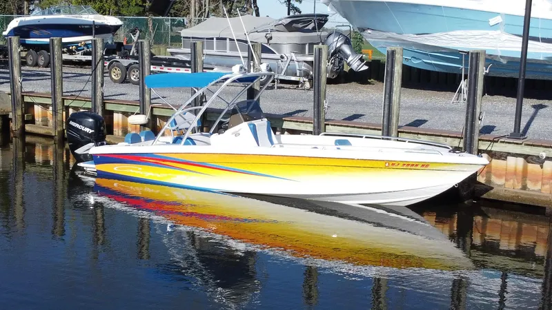 Slide: The Image of 2015 Concept 27' CC boat with vibrant yellow and blue design docked at marina. - 3