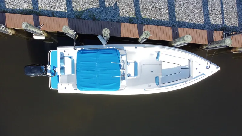 Slide: The Image of Overhead view of a 2015 Concept 27' CC boat docked by a wooden pier. - 31