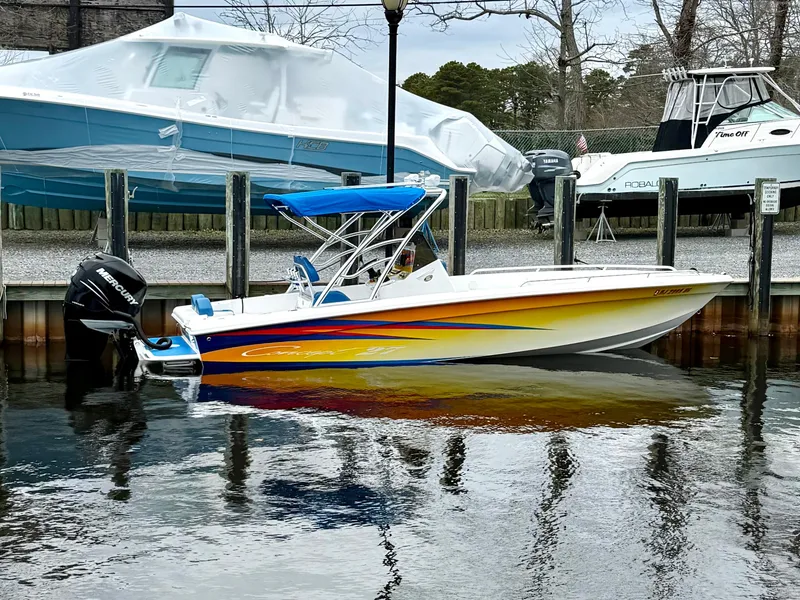 Slide: The Image of Colorful 2015 Concept 27' CC boat docked, featuring vibrant yellow and blue design. - 4