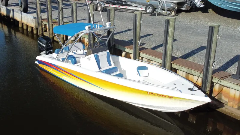 Slide: The Image of 2015 Concept 27' CC boat with vibrant stripes docked at a marina. - 5