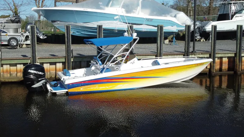 Slide: The Image of 2015 Concept 27' CC boat with vibrant stripes docked in marina. - 6