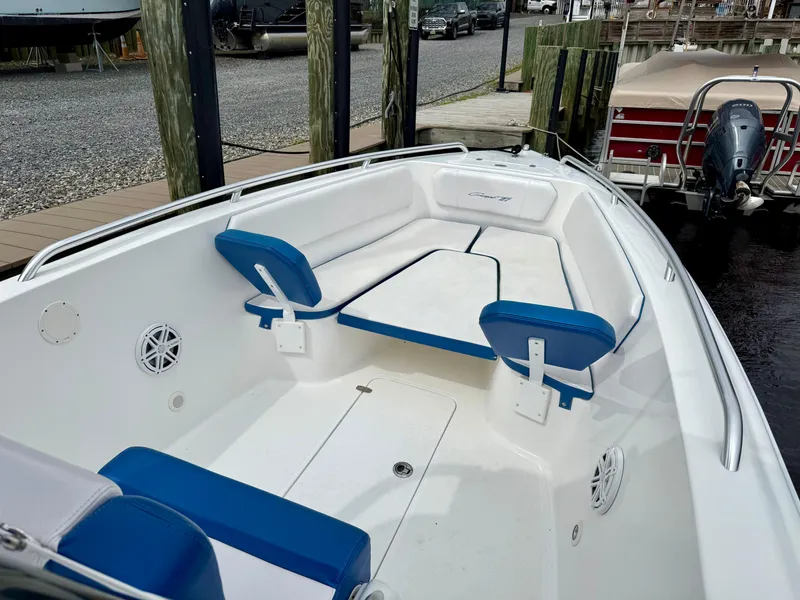 Slide: The Image of 2015 Concept 27' CC boat with blue and white seating, docked at a marina. - 7