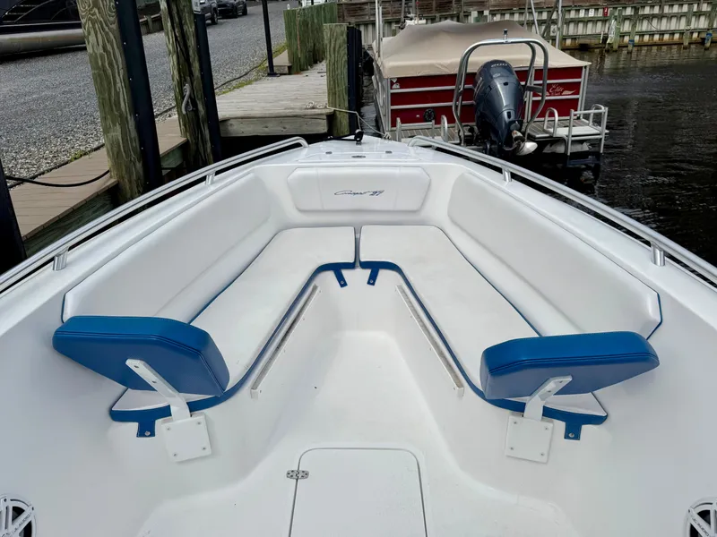 Slide: The Image of Bow seating area of 2015 Concept 27' CC boat with blue cushions at dock. - 9