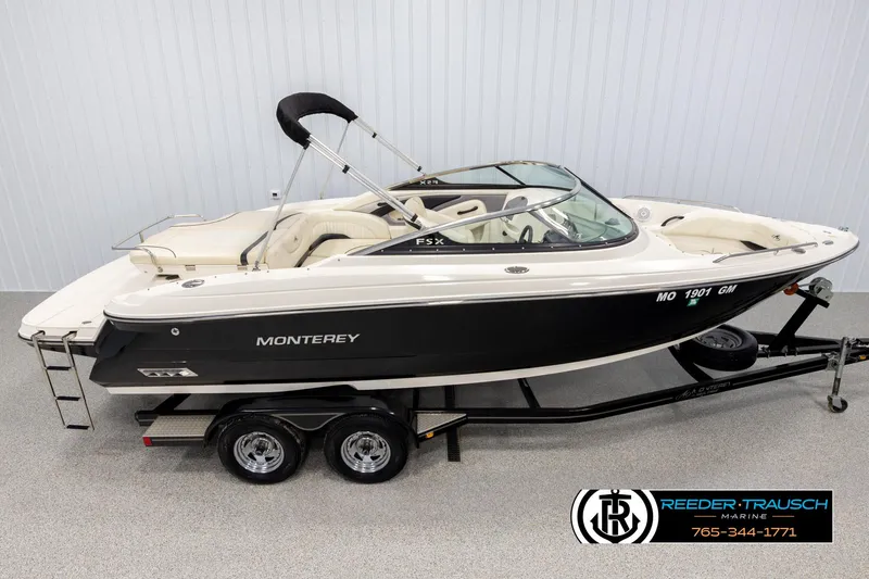 Slide: The Image of 2007 Monterey 234 FS boat on trailer, black and white design, displayed indoors. - 1