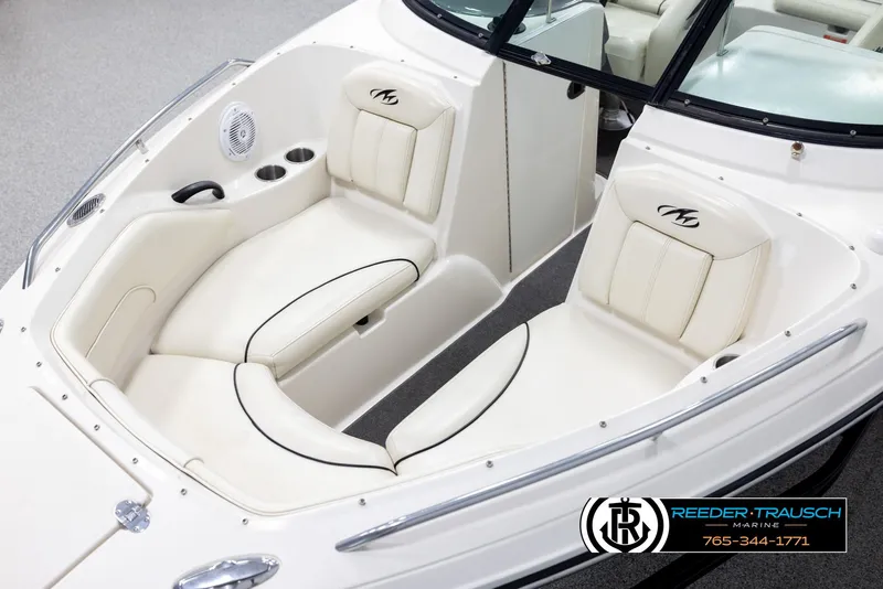 Slide: The Image of 2007 Monterey 234 FS boat interior with white seating and cup holders. - 10