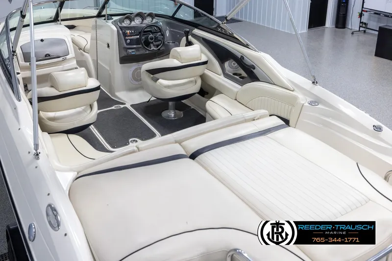 Slide: The Image of 2007 Monterey 234 FS boat interior with beige seating and modern dashboard. - 11