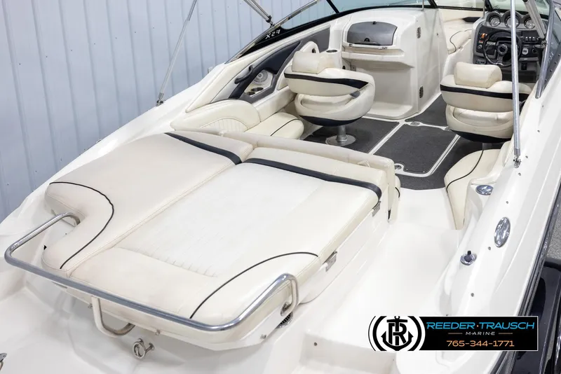Slide: The Image of 2007 Monterey 234 FS boat interior with white seating and modern dashboard. - 12