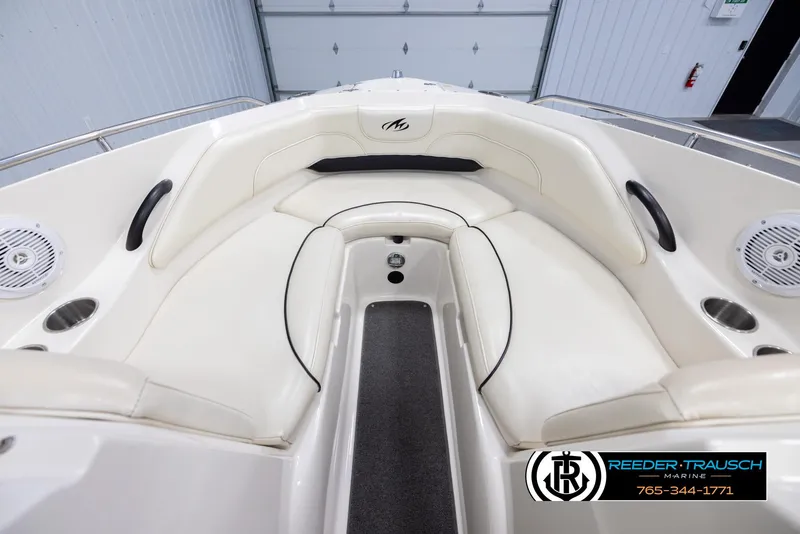 Slide: The Image of 2007 Monterey 234 FS boat interior with white seating and black accents. - 15